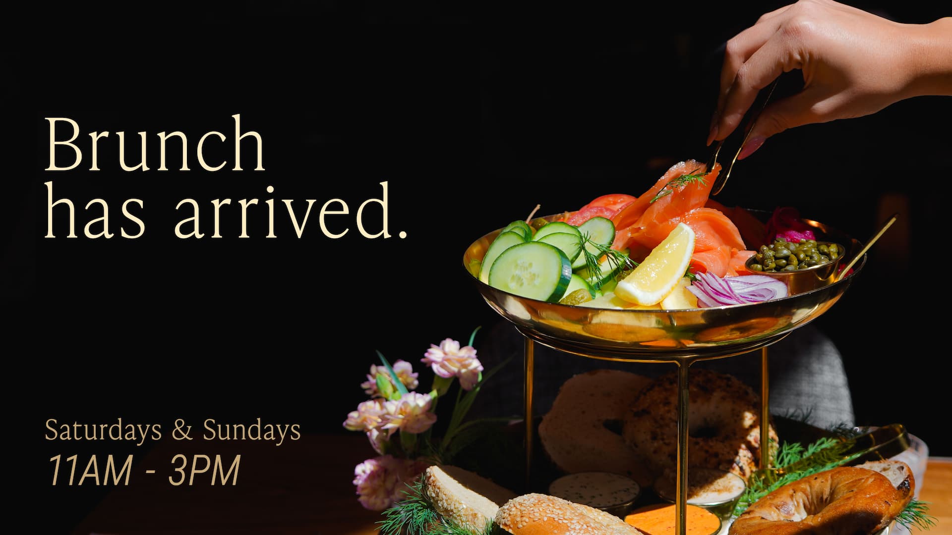 Brunch promotion featuring a lox tower with smoked salmon, cucumbers, tomatoes, capers, lemon, and bagels, available Saturdays and Sundays from 11 AM to 3 PM.